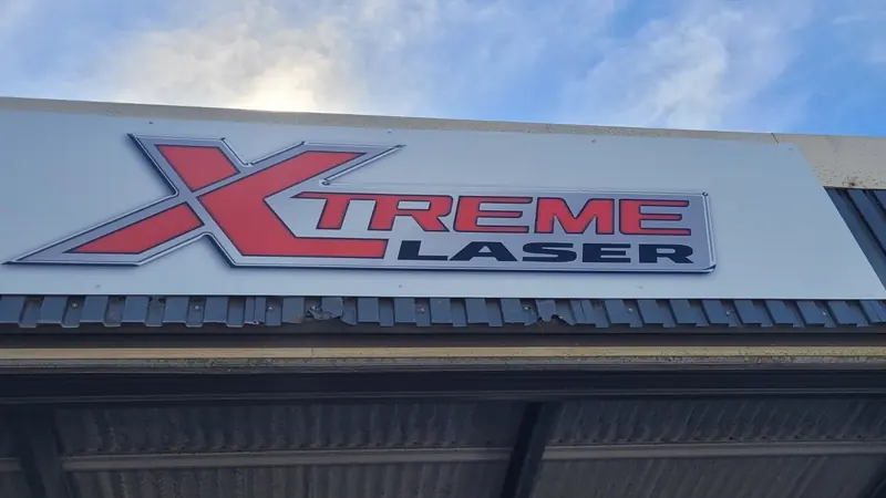 The Xtreme Laser sign on the front of the workshop building